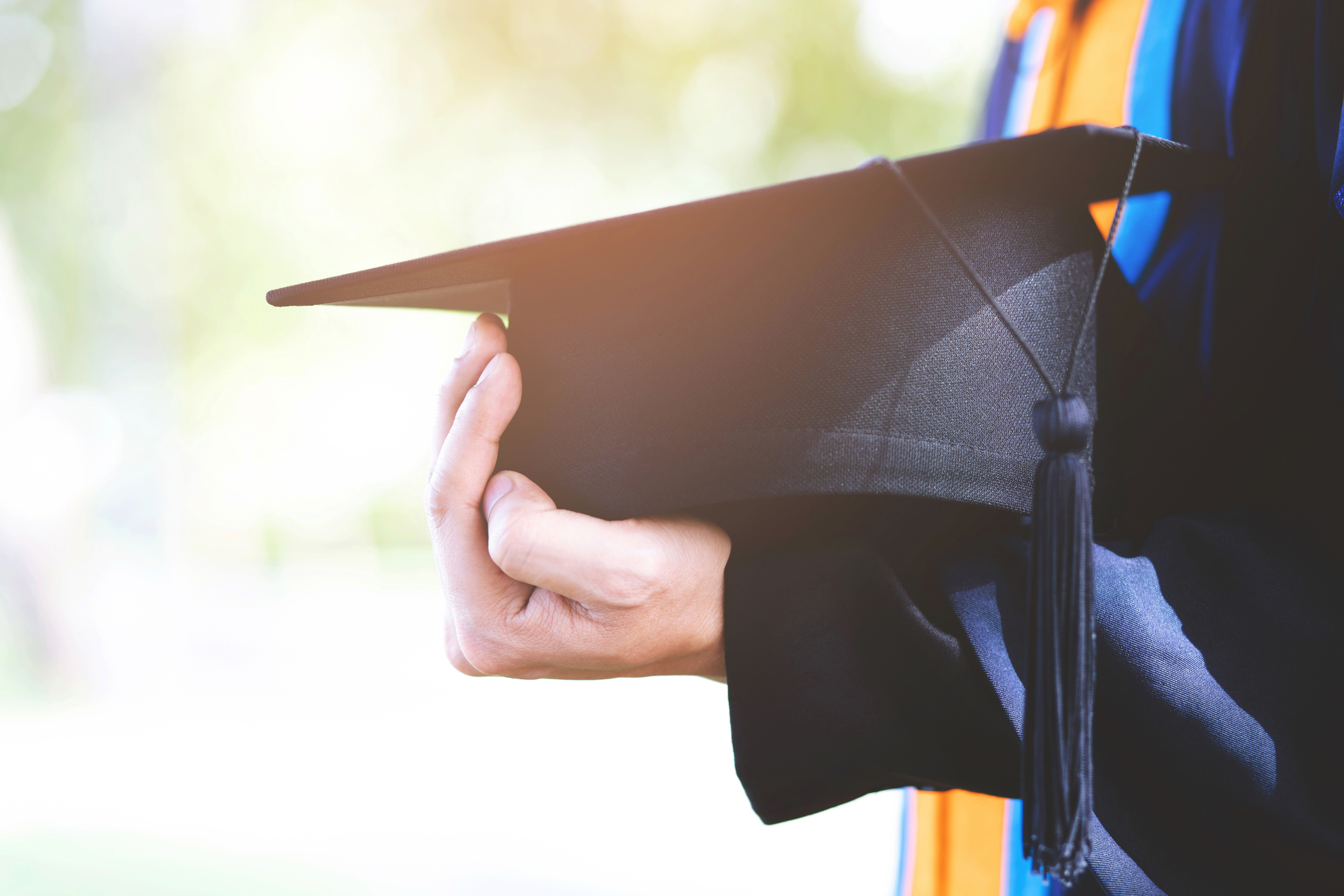 Holding Graduation Cap